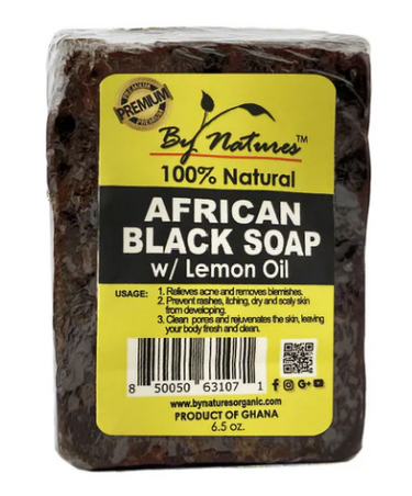 Block of African Black Soap with Lemon Oil on a white background